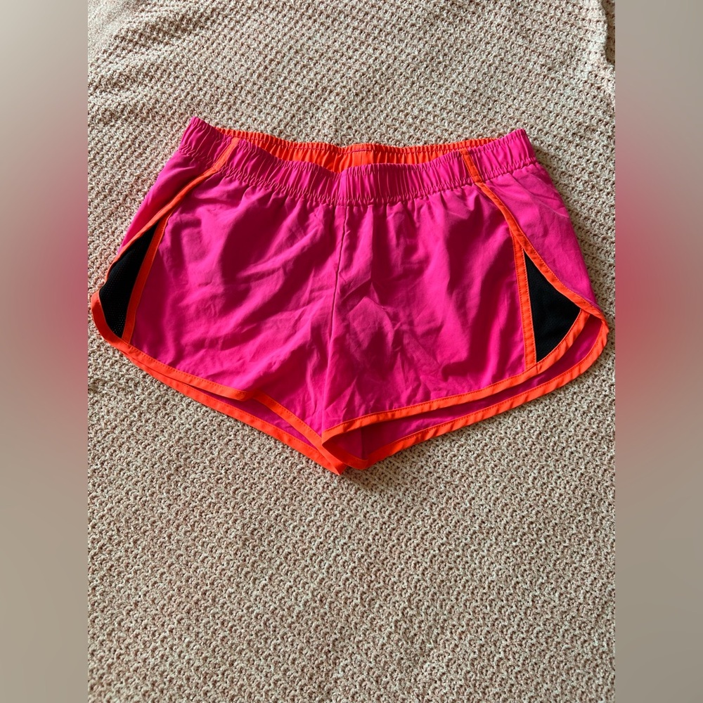 Hot pink and orange running shorts.